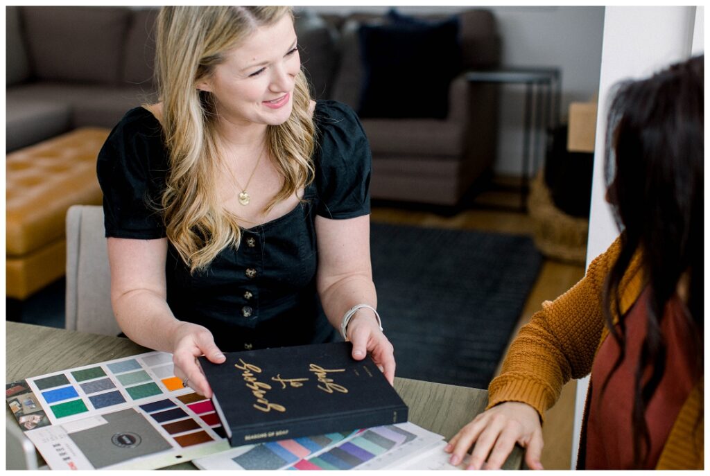 Denise Karis brand photography two women sitting at a table reviewing color swatches for a planner cover. 