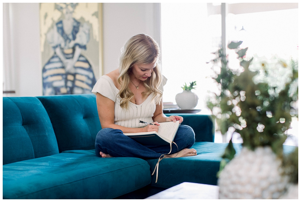 Branding Portrait of a woman wiritng in a journal. 