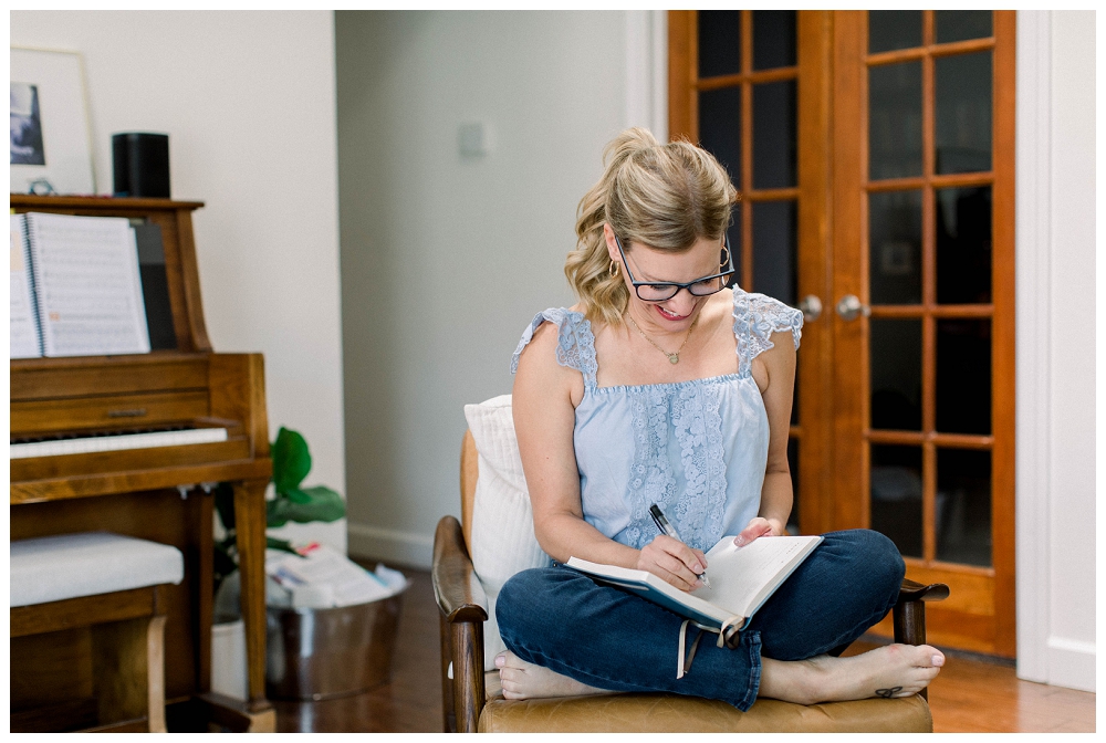 Branding portrait of a woman writing in a journal. 
