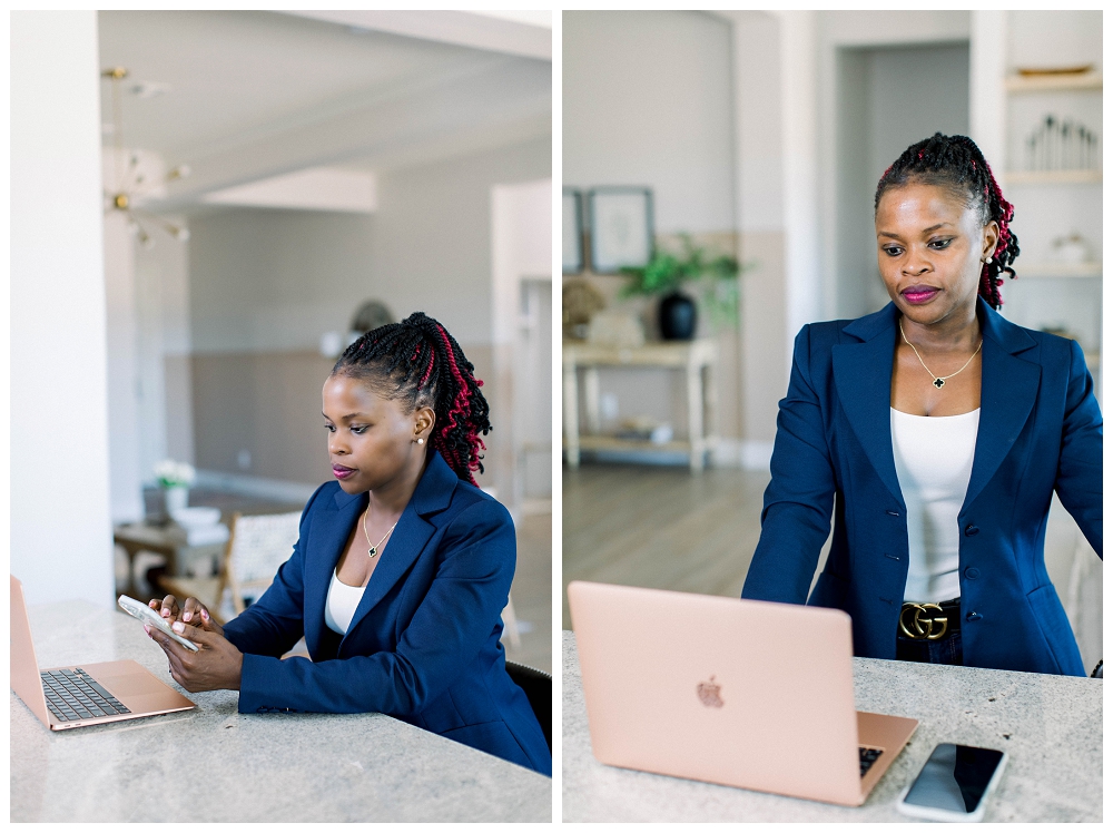 Arizona Brand Photography. A woman in a navy blazer works at a kitchen bar in a home. 