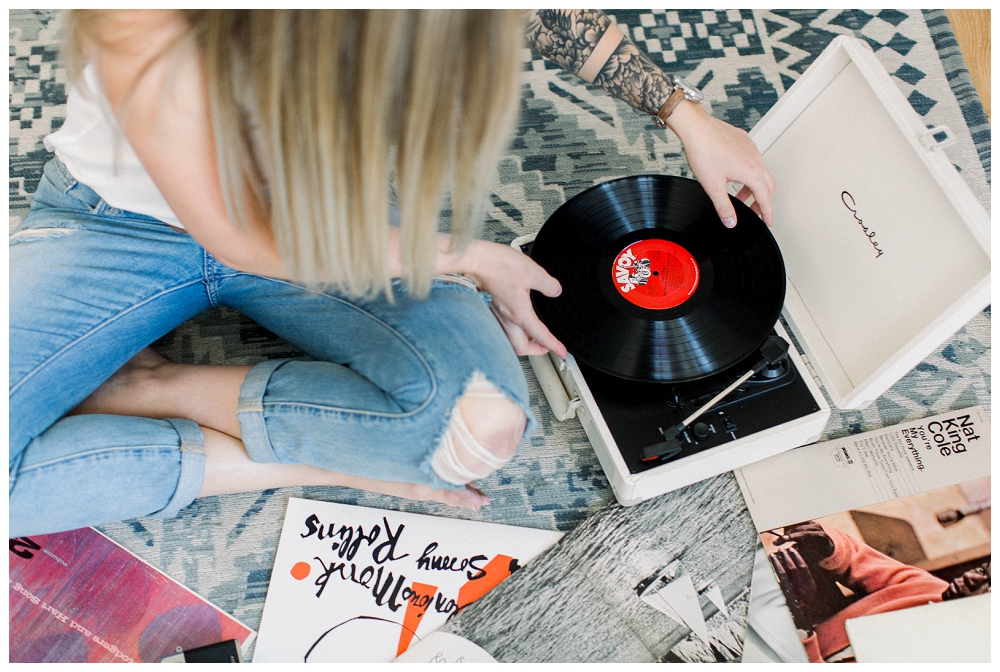 Branding portrait ariel shot of a woman putting a record on a turntable