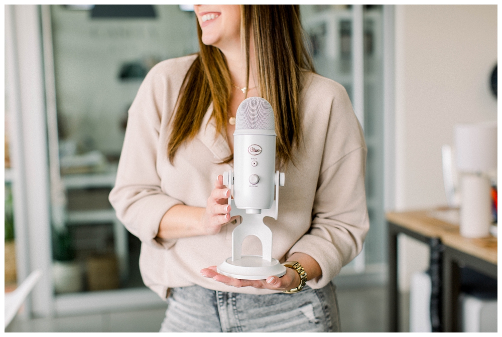 Branding portrait a woman holds a podcast mic