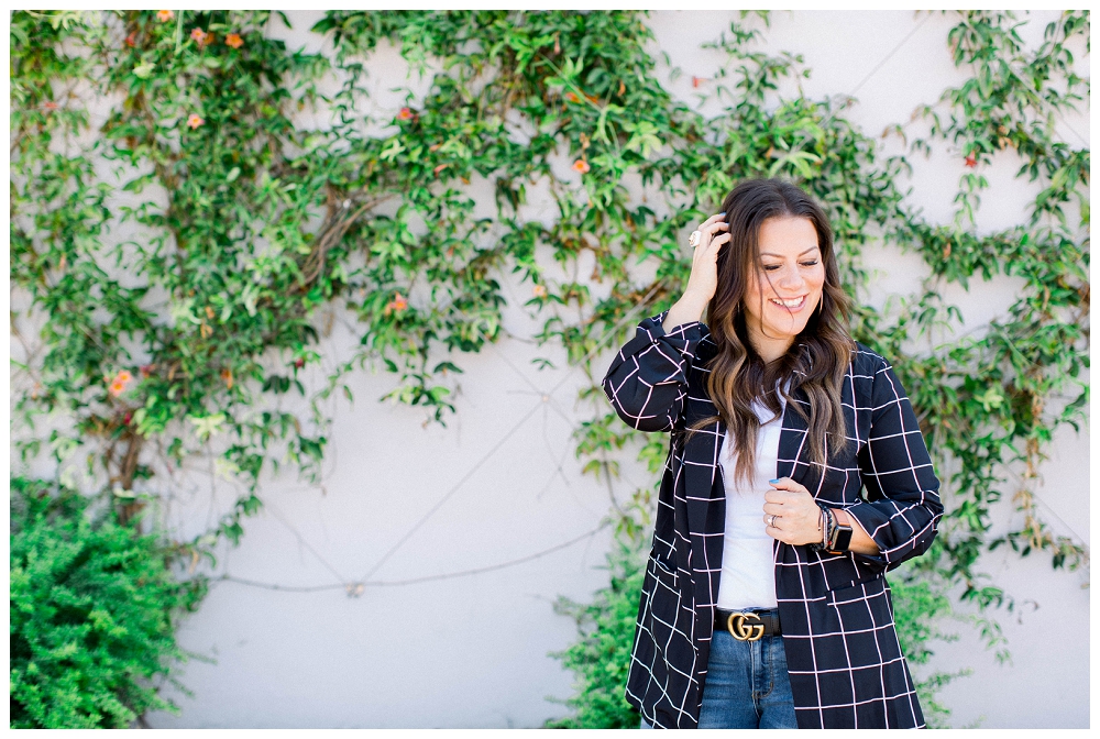 Branding Portrait of a woman standing in front of an ivy covered wall. 