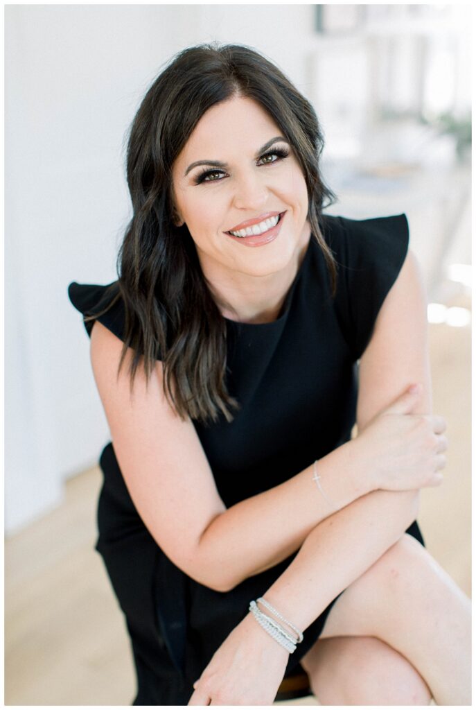 Branding Portrait a woman wearing black smiles at the camera. 