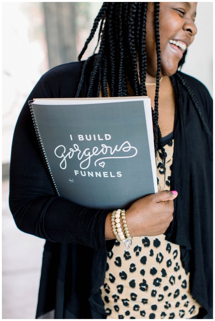 A woman holds a notebook. Branding Portrait 