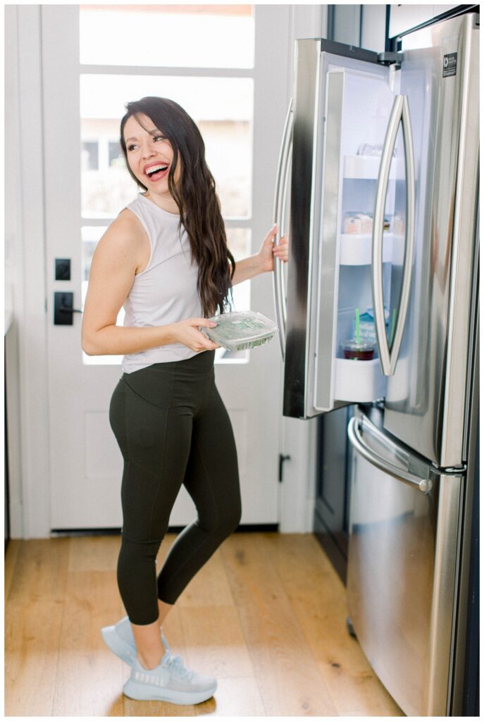 Branding Portrait a woman gets something from a fridge. 