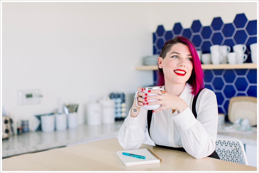 Woman with pink hair drinking coffee