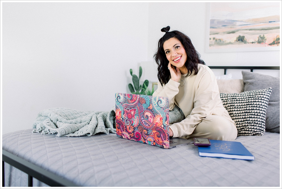 Brand Photography Woman sitting on bed with blanket and laptop