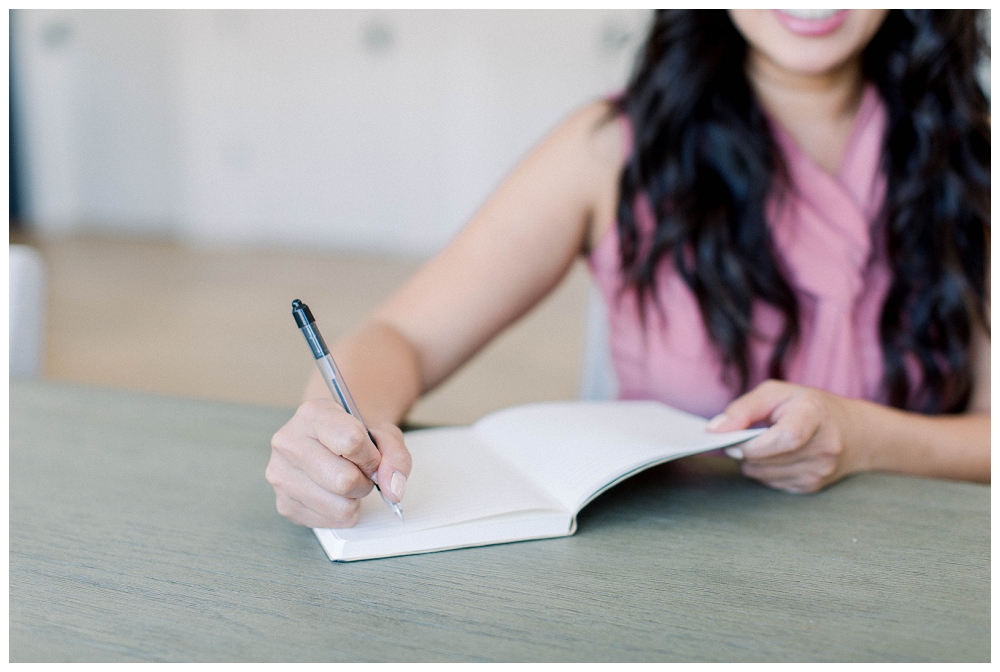 Branding portrait of a woman writing in a notebook